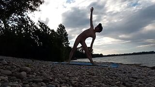 Slender nudist boy does yoga nude on a naturist beach. Naked yoga video by Jon Arteen gay porn model - 1 image
