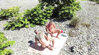 Amateur guy gives his friend a wild bareback on the beach while his friend watches in awe