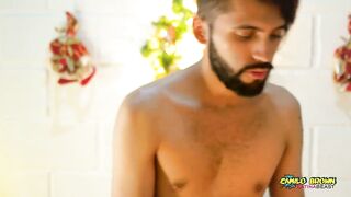 Young Uncut Latino In Colorful Christmas Wax Play With Carols In The Back - 2 image